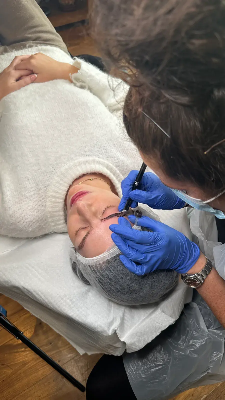 Jasmine teaching a one-to-one microblading training session